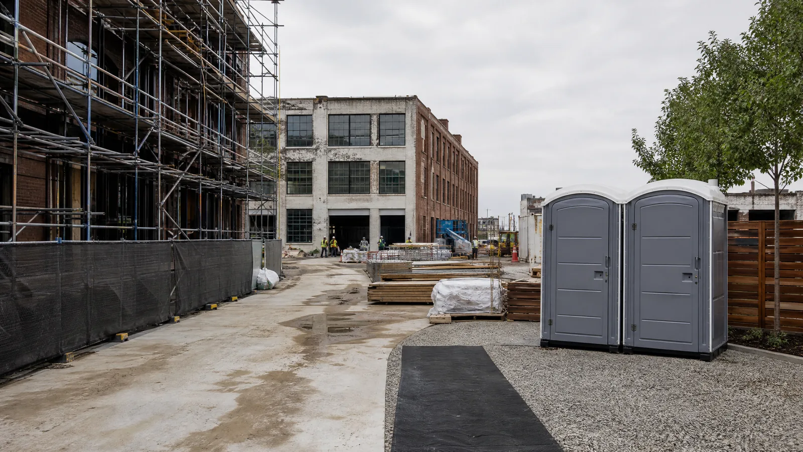 Construction site with an unobstructed access lane planned for portable restroom placement